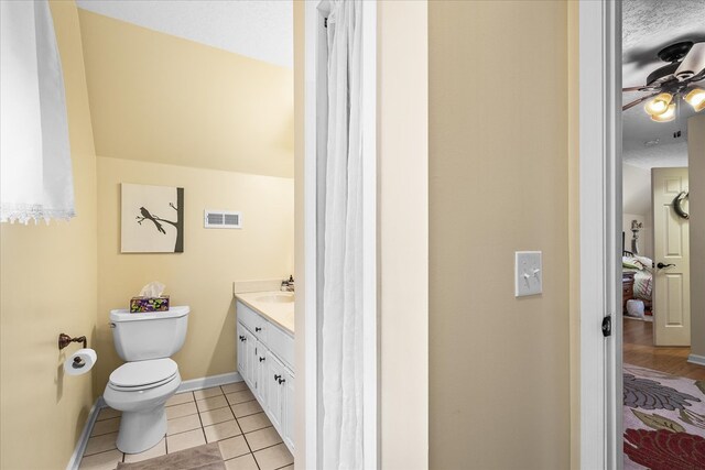 bathroom featuring visible vents, toilet, tile patterned floors, a textured ceiling, and vanity