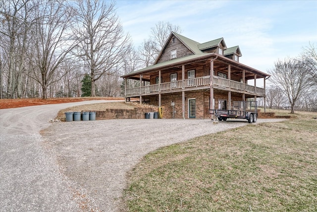 view of front of home with metal roof and a front lawn