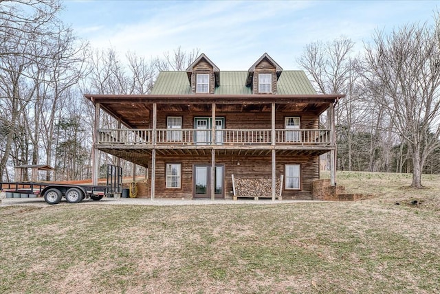 view of front of house with a front lawn and metal roof