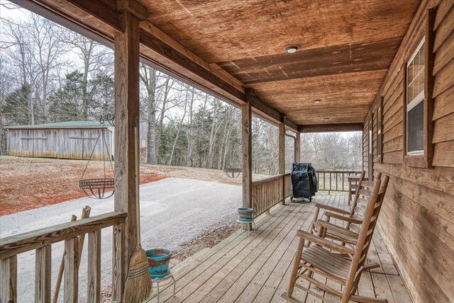 wooden terrace with a grill