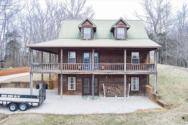 view of front of home featuring a patio area and metal roof