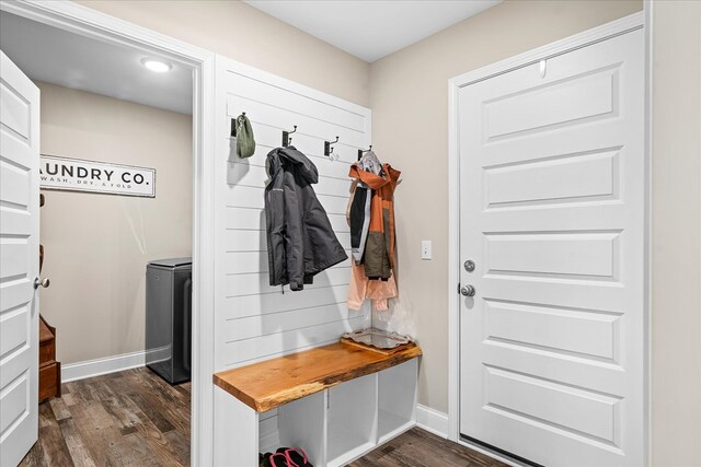 mudroom with dark wood finished floors and baseboards