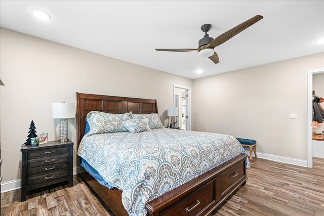 bedroom with a ceiling fan, baseboards, wood finished floors, and recessed lighting