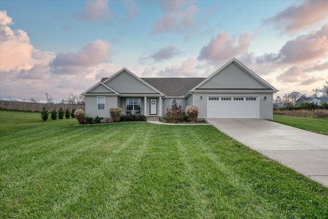 view of front of home with driveway, an attached garage, and a lawn