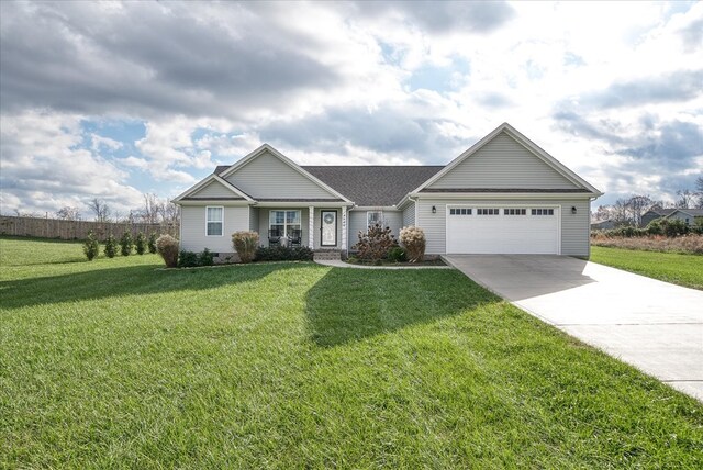 view of front of home featuring a front yard, concrete driveway, and an attached garage