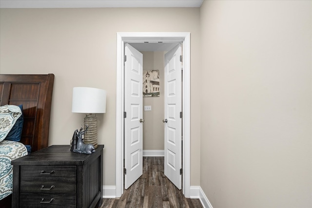 hall featuring dark wood finished floors and baseboards