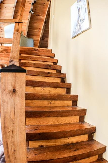 staircase with wood ceiling