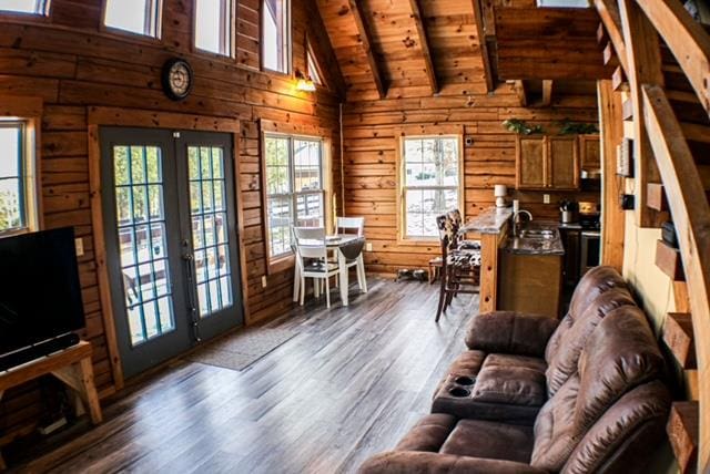 living area featuring wooden ceiling, wooden walls, dark wood-style flooring, and french doors