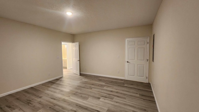 357 Taylor Rd, Byrdstown, TN 38549 - empty room with wood finished floors, a textured ceiling, and recessed lighting