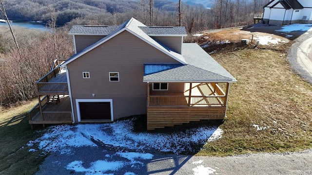 357 Taylor Rd, Byrdstown, TN 38549 - view of side of property with roof with shingles, a deck, and a view of trees