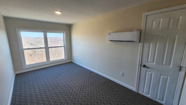 357 Taylor Rd, Byrdstown, TN 38549 - empty room with a wall unit AC, dark colored carpet, and a textured ceiling