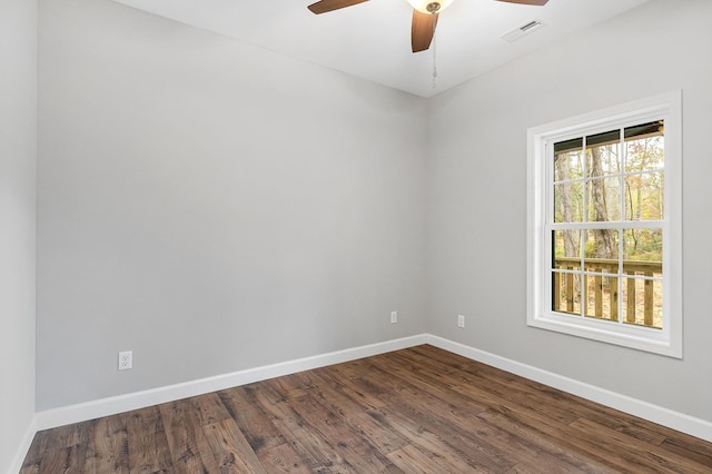 unfurnished room featuring a ceiling fan, visible vents, baseboards, and wood finished floors