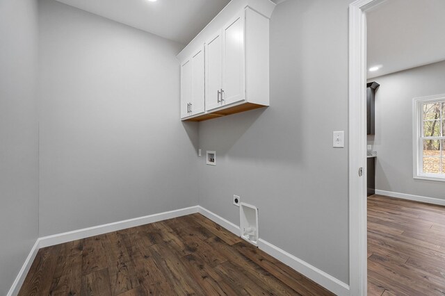 washroom with cabinet space, baseboards, dark wood-style floors, hookup for a washing machine, and electric dryer hookup