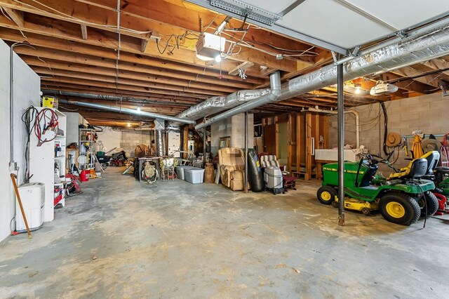 unfinished basement featuring concrete block wall