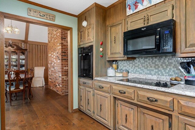 kitchen featuring black appliances, dark wood-style floors, brown cabinets, and pendant lighting