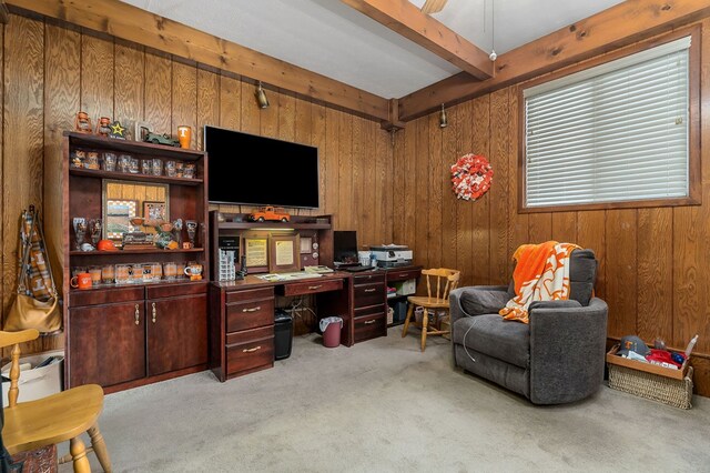 office area with light colored carpet, beamed ceiling, and wooden walls