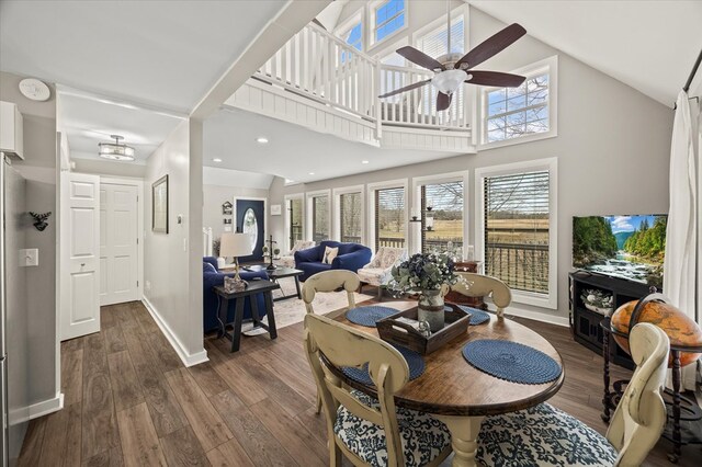 living area featuring dark wood finished floors, recessed lighting, a ceiling fan, high vaulted ceiling, and baseboards