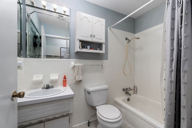 full bathroom featuring a textured ceiling, toilet, vanity, tile walls, and shower / bathing tub combination