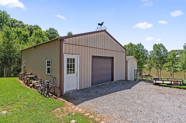 detached garage with gravel driveway