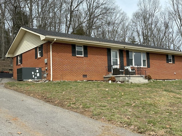 ranch-style home featuring a front lawn, central AC unit, brick siding, and crawl space