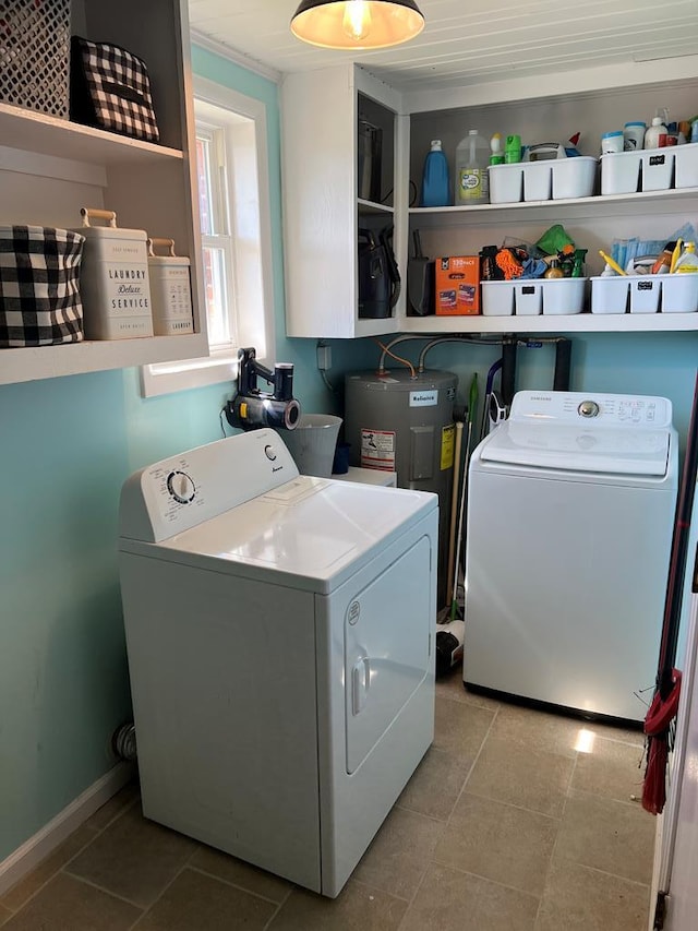 clothes washing area with tile patterned flooring, laundry area, washing machine and dryer, and electric water heater