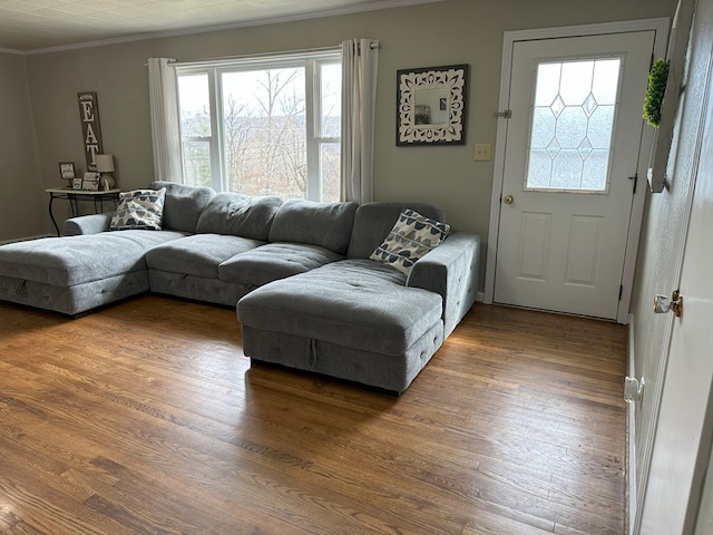 living area with crown molding and wood finished floors