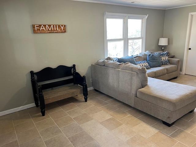 living area featuring baseboards and ornamental molding