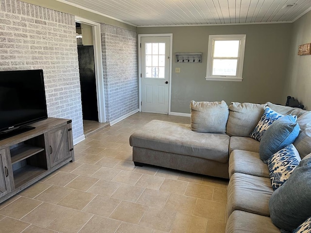 living area featuring crown molding, wood ceiling, and brick wall