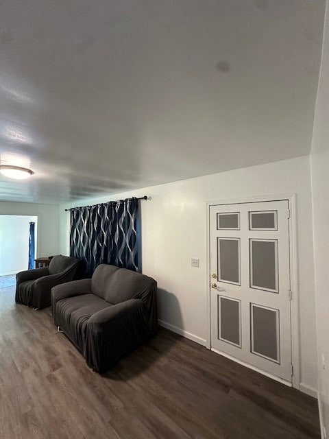 living area with dark wood-style floors and baseboards