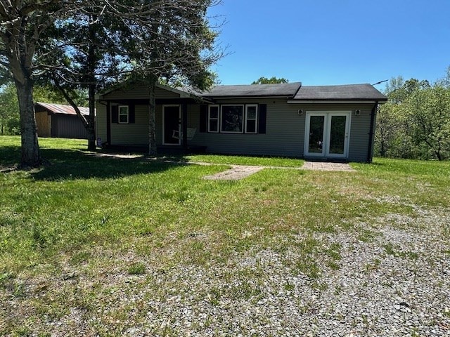 rear view of property featuring a lawn