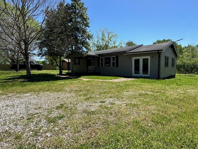 view of front of property with a front lawn and french doors