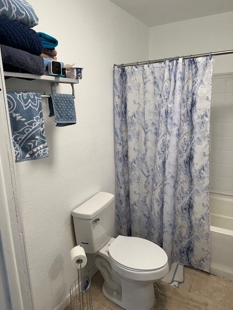 full bathroom featuring toilet, shower / tub combo, and tile patterned floors