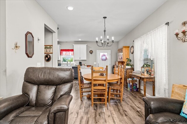 dining area featuring light wood-style floors, a chandelier, and recessed lighting