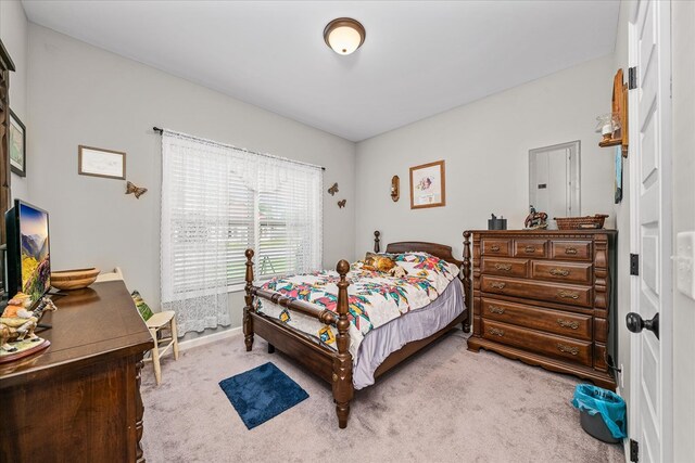 carpeted bedroom with baseboards