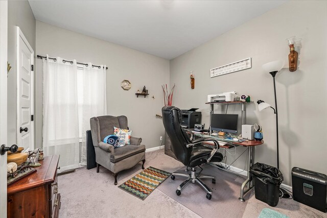 office space with baseboards and light colored carpet