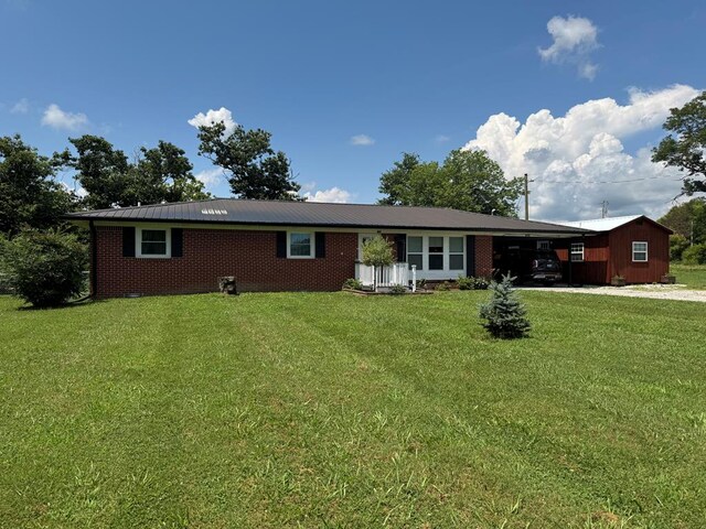 8298 Southfork Rd, Baxter, TN 38544 - single story home with a carport, a front lawn, driveway, and brick siding