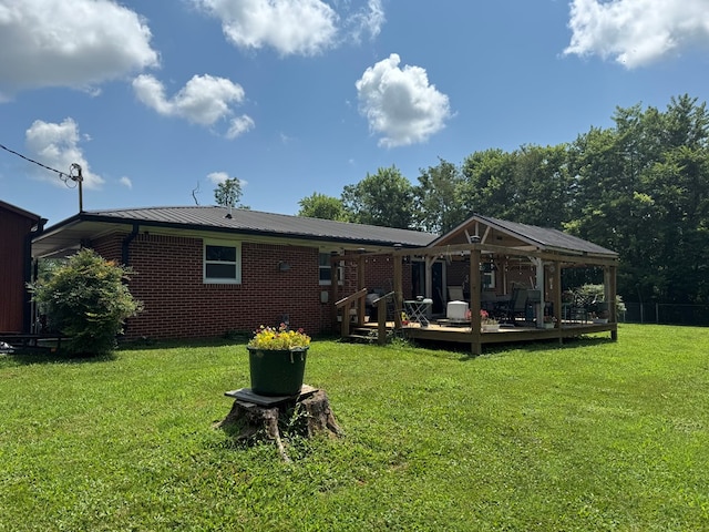 8298 Southfork Rd, Baxter, TN 38544 - back of house featuring a lawn, a deck, a metal roof, and a gazebo