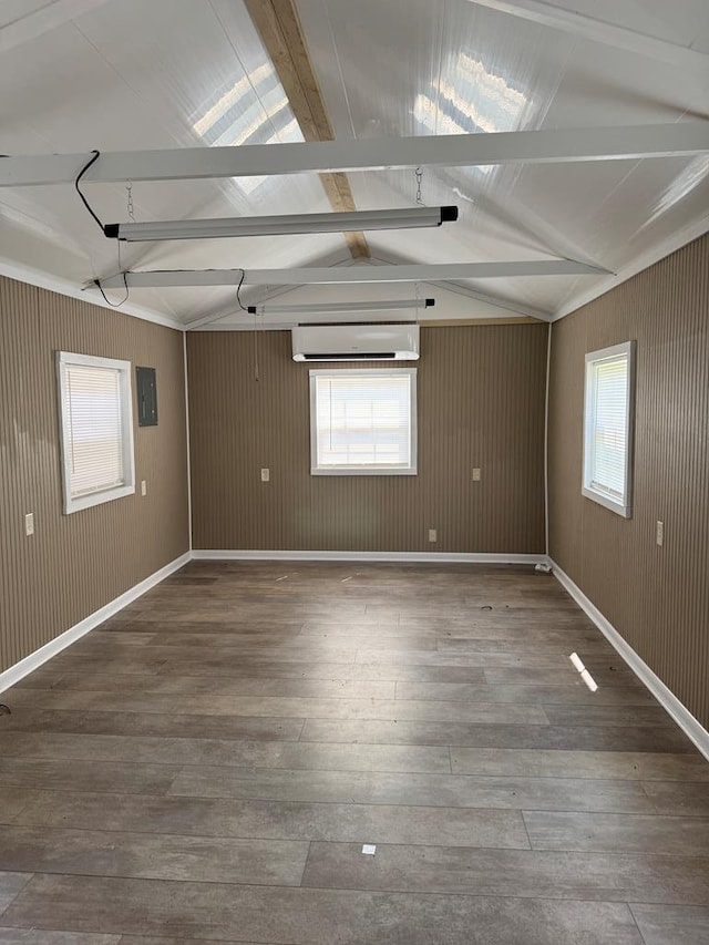 8298 Southfork Rd, Baxter, TN 38544 - empty room featuring wood-type flooring, an AC wall unit, and plenty of natural light