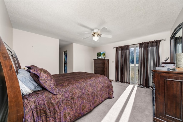 bedroom with light carpet, ceiling fan, a textured ceiling, and access to exterior