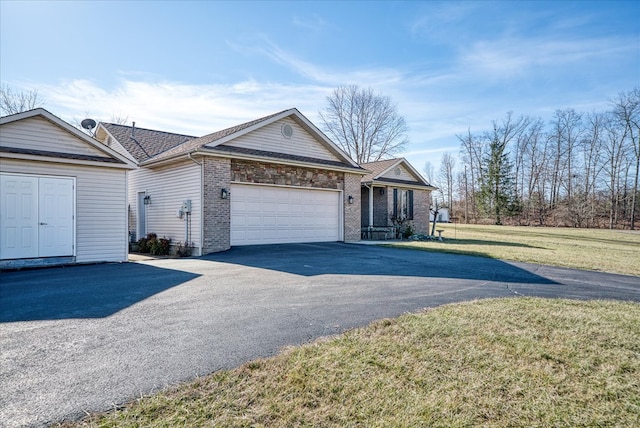 ranch-style home with an attached garage, brick siding, a shingled roof, driveway, and a front yard