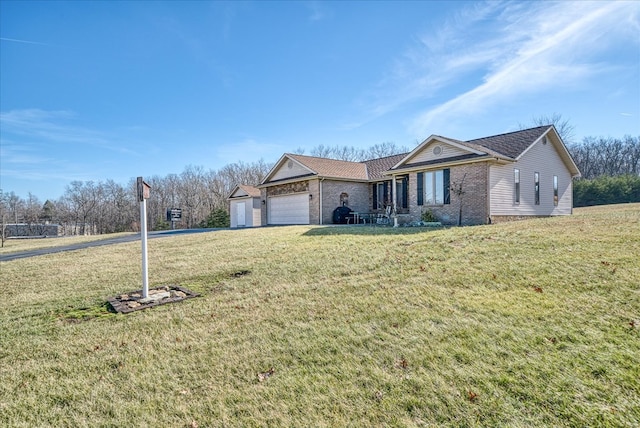 ranch-style house with a garage, brick siding, and a front lawn