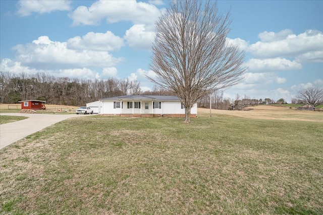 view of front of home with driveway and a front lawn