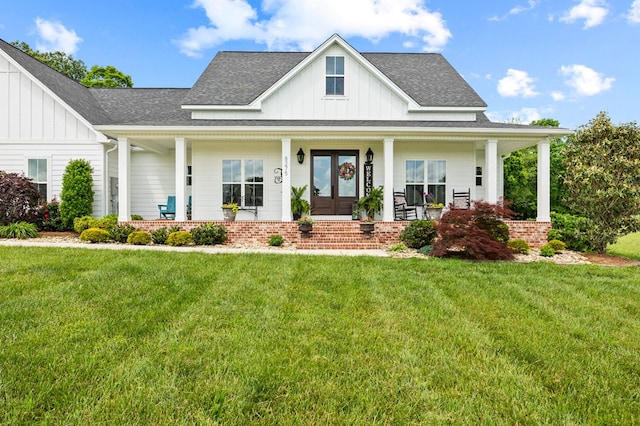8275 Medlin Rd, Baxter, TN 38544 - modern farmhouse featuring board and batten siding, covered porch, roof with shingles, and a front yard