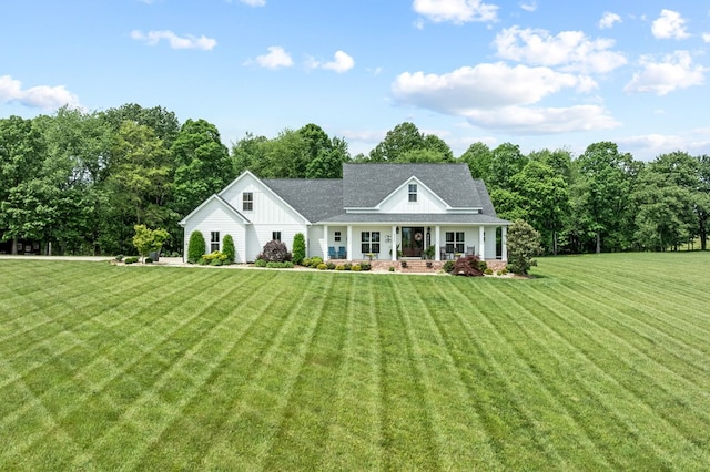 8275 Medlin Rd, Baxter, TN 38544 - view of front of home with a porch, board and batten siding, a front yard, and a shingled roof