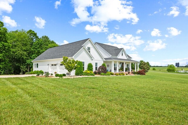 8275 Medlin Rd, Baxter, TN 38544 - view of front of house with a porch, a front lawn, a garage, board and batten siding, and driveway