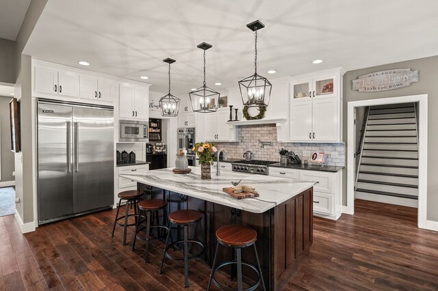 8275 Medlin Rd, Baxter, TN 38544 - kitchen with built in appliances, dark wood-type flooring, decorative backsplash, glass insert cabinets, and recessed lighting