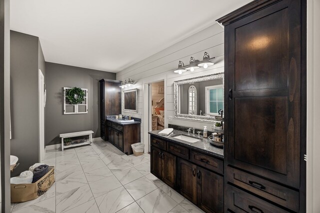 8275 Medlin Rd, Baxter, TN 38544 - full bathroom featuring marble look tile flooring, two vanities, and wood walls