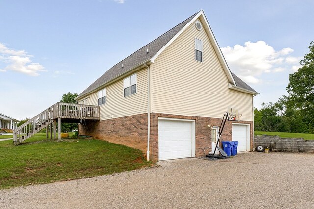 1841 SW Jones Chapel Rd, Byrdstown, TN 38549 - view of home's exterior with brick siding, stairs, an attached garage, a wooden deck, and a yard