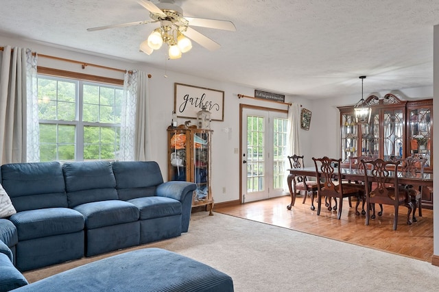 1841 SW Jones Chapel Rd, Byrdstown, TN 38549 - living area with light carpet, a textured ceiling, a ceiling fan, and baseboards