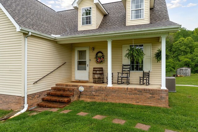 1841 SW Jones Chapel Rd, Byrdstown, TN 38549 - property entrance featuring a porch, a lawn, roof with shingles, and cooling unit